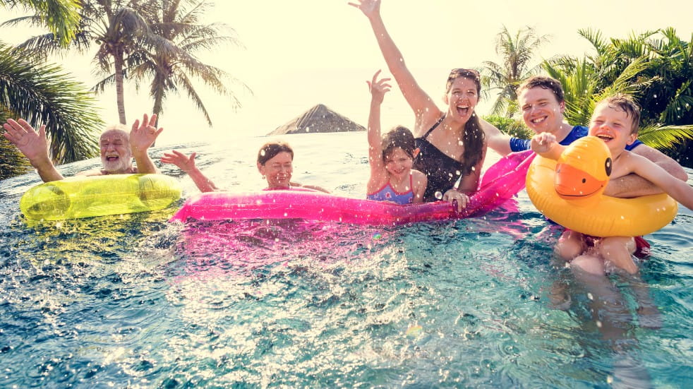 Family on holiday in pool